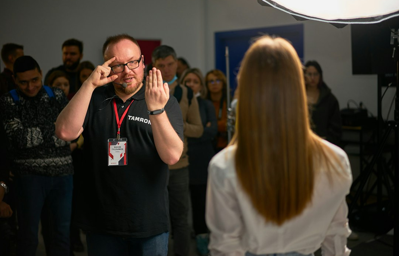 An event manager briefing a team of formally dressed adult hosts before a themed evening