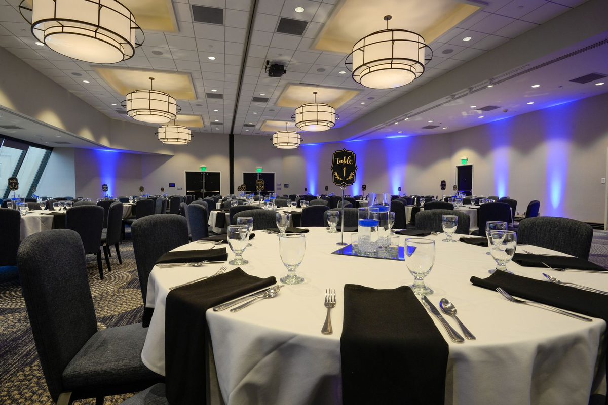 Colleagues in business formal attire gathered around a casino-themed event table at a corporate evening