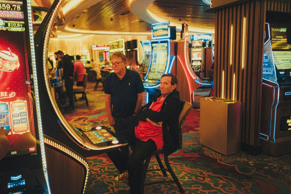 Casino-themed event tables being positioned and levelled in a venue before guests arrive