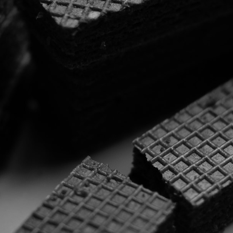 Close detail of unmarked symbolic event chips stacked on a dark table surface